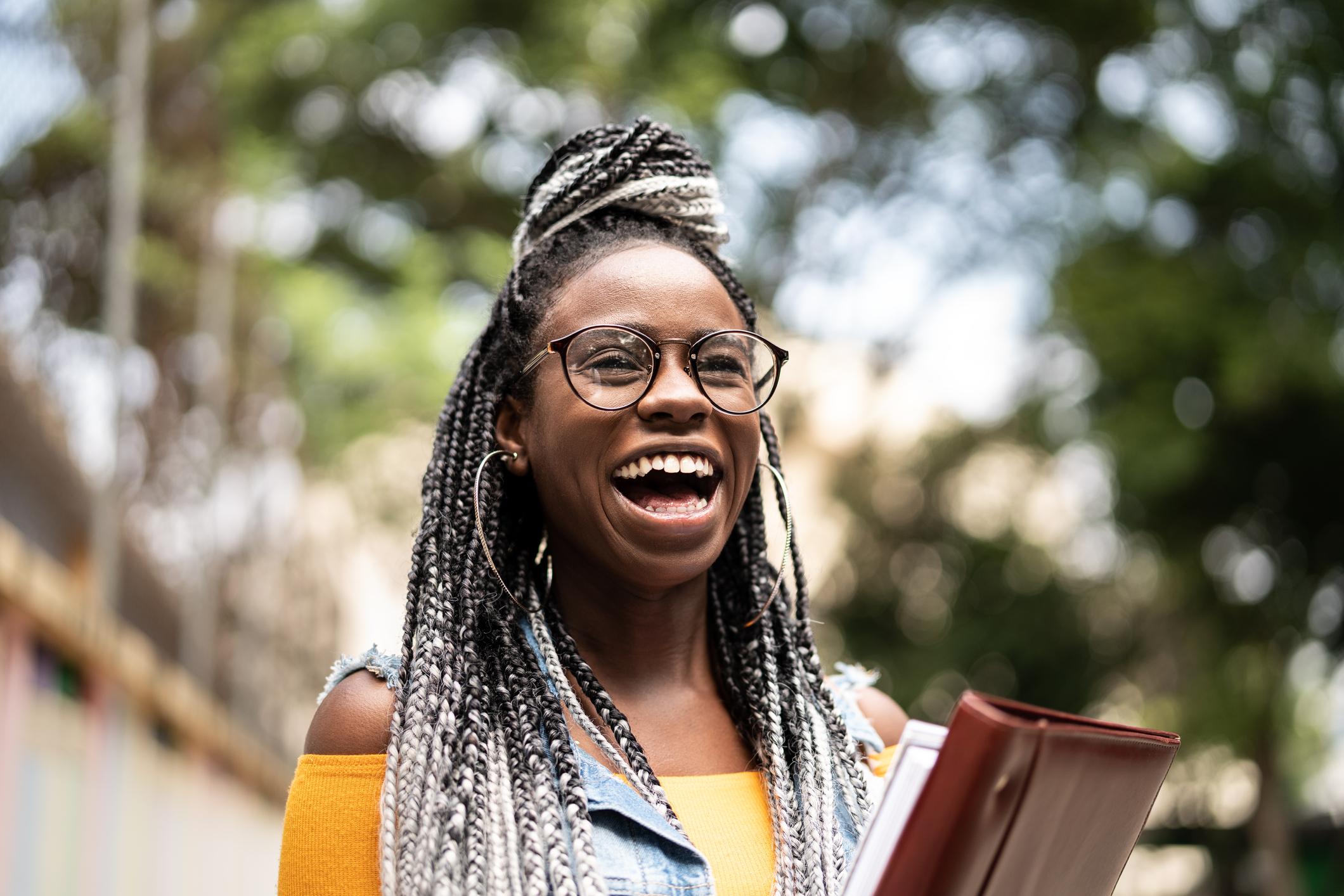 Smiling student holding folder